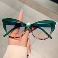 Detail view of cat-eye sunglasses featuring green frames and leopard print accents - Green Leopard Patchwork Frame Blue Tea Lens