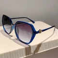 Detail of transparent blue oversized sunglasses with golden rhinestone crown accents - Blue Frame Gradient Grey Lens