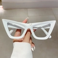Close-up of white cat-eye glasses frames with a bold triangular silhouette and wide temples - Solid White Frame Clear Lens