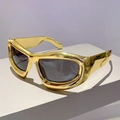 Futuristic Y2K gold wrap-around sunglasses with sleek dark lenses from a 45-degree angle - Electroplated Gold