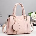 Elegant pale pink tote bag with textured faux leather and a mini coin purse charm - Pink