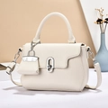 Beige litchi leather handbag with top handle and mini charm, elegant geometric scene - White