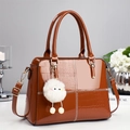 Brown patent leather crossbody bag with croc-embossed detail and plush monster charm - Khaki/Earth Yellow
