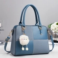 Minimalist blue patchwork leather handbag with woven texture and plush charm - Blue