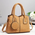 Elegant camel faux leather handbag for women with dual handles and round coin purse charm - Earthy Yellow