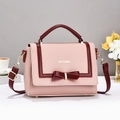 Pink lychee grain leather crossbody bag with wine red bow decoration and gold hardware - Pink
