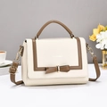 Chic beige crossbody bag with brown trim and bow detail in a stylish lifestyle setting - Off-white