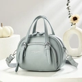 Blue-grey pebbled leather handbag with crossbody strap and front zipper pocket detail - Sky Blue