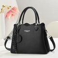 Black pebble leather handbag with wavy edge and crossbody strap on elegant background - Black