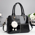 Black contrast tote bag with crocodile texture, fur ball charm, and shoulder strap - Black