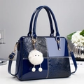 Deep blue contrast panel handbag with crocodile texture and furry eye charm accessory - Blue