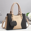 Elegant grey and beige crossbody bag with woven texture and mini charm on white table - Black