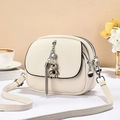 Minimalist beige pebble leather crossbody bag with silver chain and bear charm detail - Off-white
