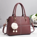 Burgundy faux leather handbag with crocodile pattern, contrast stitching and fuzzy charm - Burgundy