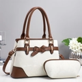 Close-up of white snakeskin pattern tote bag with brown leather trim and gold hardware - Off White