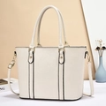 Minimalist beige faux leather tote bag with black edge piping and gold hardware - Off-white