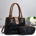Detailed view of black snakeskin patterned two-piece handbag set with gold clasp - Black