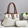 Detail view of two-piece tote bag set with faux snakeskin texture and gold teardrop lock - Off White
