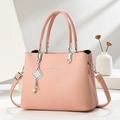 Pink litchi texture Boston tote bag with silver charm and pearl detail in elegant setting - Pink