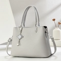 Light gray pebbled leather tote bag with silver hardware and chic tassel pendant - Gray