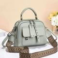Mint green leather handbag for women featuring a patterned wide strap and silver hardware - Green