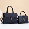 Detail of navy blue bag set featuring textured leather patchwork and golden metal lock - Two-Piece Set / Blue