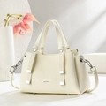 Close-up of cream leather texture with silver metal rivets and fashion branding logo - Off-white