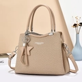 Elegant khaki woven crossbody bag with star tassel and dual handles on minimalist background - Khaki