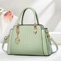 Elegant mint green pleated leather handbag with gold ballet charm and shoulder strap - Green