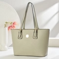Detail of sage green tote bag showing lychee grain texture and gold metal accents - Green