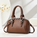 Brown lychee leather handbag with dual handles and silver hardware on white background - Coffee