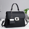 Minimalist black lychee leather handbag with silver G buckle and stylish chain charm - Black