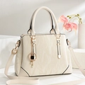 Elegant beige marble-textured tote bag with luxury gold hardware and clover pendant detail - Off White