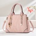 Pink handbag with marble texture, clover charm, and pearl detail on white stone stand - Pink (Marble Pattern)