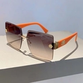 Detail of rimless square sunglasses with gradient brown lenses and orange stems - Orange Temples Gradient Tea Lenses