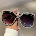 Close-up of oversized sunglasses featuring crystal rhinestones and purple gradient lenses - Black Frame Double Gray Lens