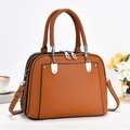 Macro detail of brown pebbled leather texture and silver buckle on tote bag - Earthy Yellow