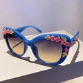 Blue cat eye sunglasses featuring pink 3D flower decorations and gradient brown lenses - Blue and Yellow