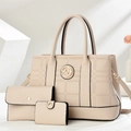Beige embossed three-piece handbag set featuring tote and matching wallets on white stands - Off-white