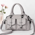 Light grey pebble leather boston bag with side pockets and a wide woven shoulder strap - Gray