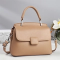 Khaki minimalist crossbody bag with lychee grain leather and round handle on gray background - Khaki