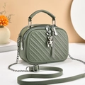 Olive green mini crossbody bag with quilted pattern, silver bear charm and tassel detail - Green