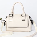 Minimalist cream leather Boston bag with side pockets and wide shoulder strap in studio shot - Off White