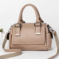 Detailed view of the khaki pebbled leather bag texture with adjustable wide strap and hardware - Khaki