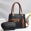 Detail of black woven texture handbag with brown handles and gold zipper hardware - Black