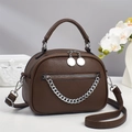 Detailed view of dark brown litchi leather bag with silver chain and dual zippers - Coffee