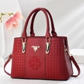 Detail of red leather handbag with geometric embroidery and gold HRADB metal logo - Wine Red