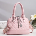 Detailed view of pink quilted shell bag featuring rhinestone heart tassel and wide strap - Pink
