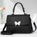 Elegant black lychee leather handbag with silver butterfly clasp and top handle - Black