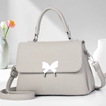 Chic light gray pebbled leather handbag with silver butterfly clasp and shoulder strap - Gray